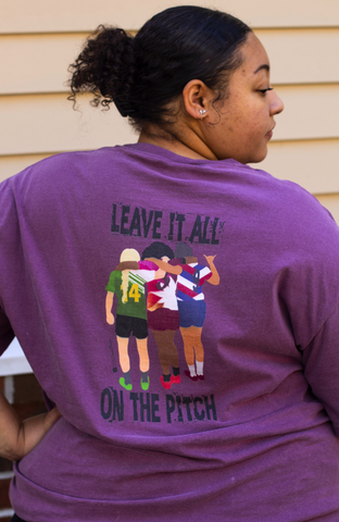 Woman with back turned wearing the Leave it All On the Pitch T-shirt